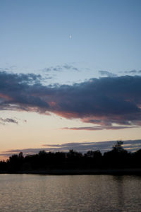 Scenic view of lake against sky at sunset