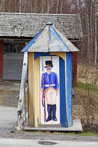 Portrait of man standing outside house