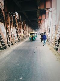 Rickshaw and people on bridge