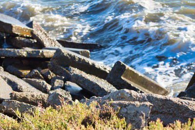 High angle view of rocks by sea