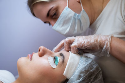 Midsection of doctor examining patient at clinic