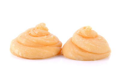 Close-up of bread in plate against white background