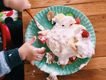 Cropped image of hand holding ice cream