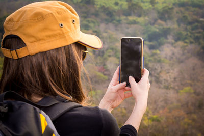 Midsection of woman using mobile phone