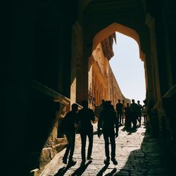 Silhouette of people at archway