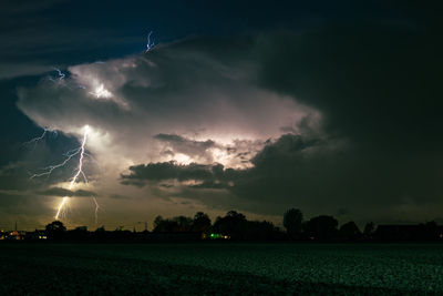 Branched lightning strikes down from the top of the thunderstorm