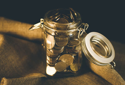 Coins in glass jar on fabric