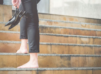 Low section of person standing on steps