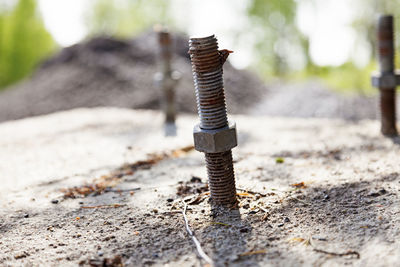 Metal stick with rusty bolt