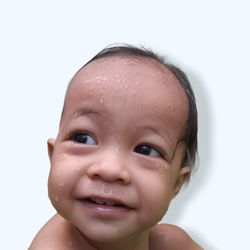 Portrait of cute baby boy against white background