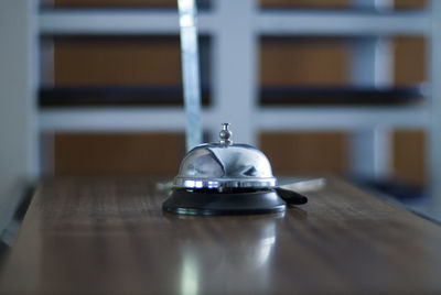 Close-up of service bell on wooden table