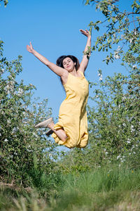 Low angle view of woman standing on field