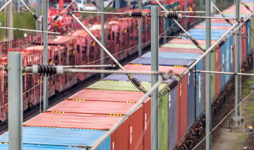 Telephoto recording of a freight wagon on the rails with coloured containers
