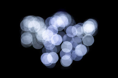 Defocused image of lights against black background