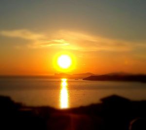 Scenic view of sea against orange sky