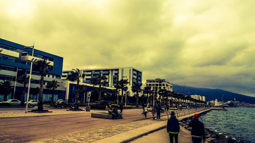 Panoramic view of city by sea against sky