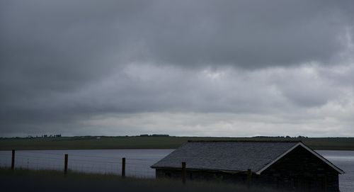 Houses against cloudy sky