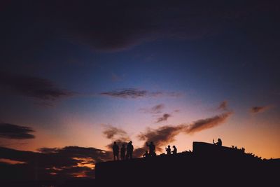 Low angle view of silhouette trees against sky at sunset