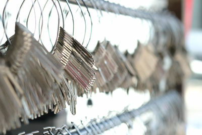 Close-up of clothes hanging on metal grate