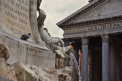 Low angle view of statue against historic building