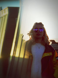 Portrait of woman wearing sunglasses standing outdoors