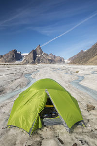 Green tent perched on glacier below mt. loki, baffin island.