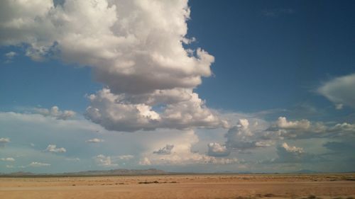 Scenic view of landscape against cloudy sky