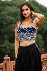 Portrait of a beautiful young woman standing outdoors