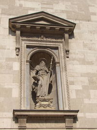 Low angle view of statue against building