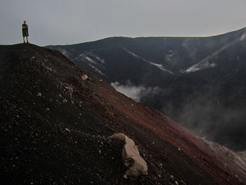 Man on mountain against sky