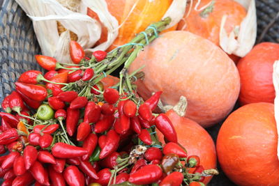 High angle view of pumpkins and red chili peppers at market