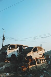 Abandoned car against clear sky
