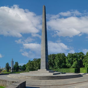 Low angle view of monument against cloudy sky