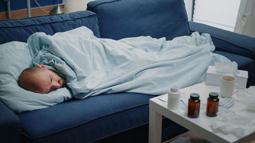 Young woman sleeping on bed at home