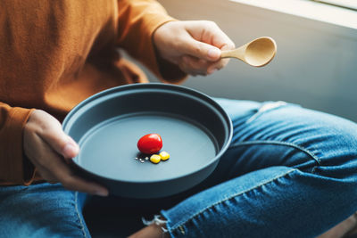 Midsection of man sitting in bowl