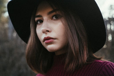 Close-up portrait of young woman looking away