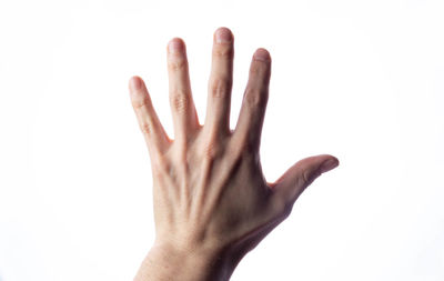 Close-up of human hand against white background