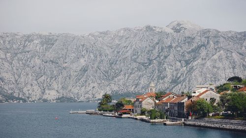 Scenic view of sea and mountains against clear sky