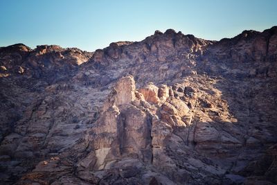 Rock formation in mountains against clear sky