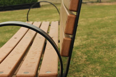 Empty bench on field at park