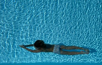 High angle view of woman swimming in pool