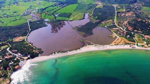 Scenic view of sea by farm