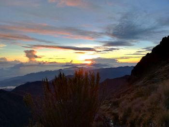 Scenic view of silhouette mountains against sky at sunset