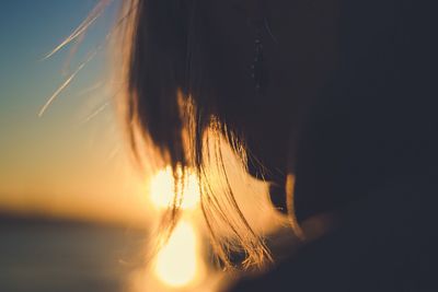 Close-up portrait of woman against sky during sunset