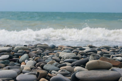 View of pebbles on beach against sky
