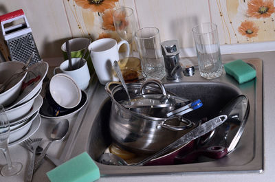 Kitchen utensils in sink at home