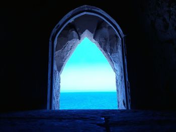 Scenic view of sea against sky seen through arch