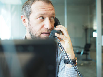 Close-up of man working on mobile phone