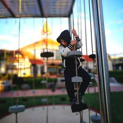 Full length of boy playing at playground