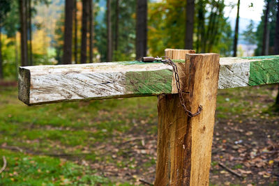 Close-up of wooden post tied up fence